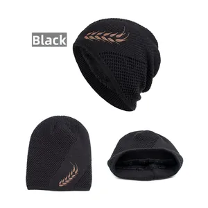 Detail of black winter knit hat featuring wheat ear embroidery and thick fleece lining