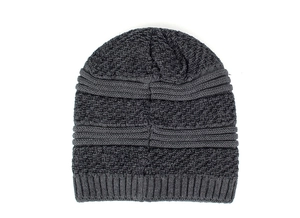Close-up of dark grey knit beanie showing thick texture and ribbed cuff detail