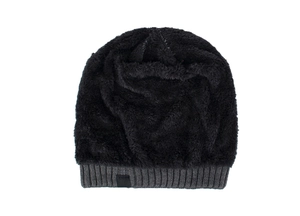Close-up of black knit hat showing thick faux lamb wool lining and ribbing detail