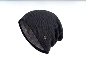 Close-up of knit winter beanie featuring thick grey fleece lining and metal H logo detail