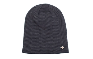 Macro detail of dark grey herringbone knit texture and metal logo plaque on a winter beanie