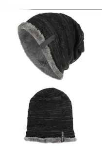 Detailed view of the dark knit beanie with thick grey fleece lining and side fabric label