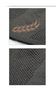 Close-up of dark grey beanie featuring a honeycomb knit texture and laurel wreath embroidery
