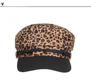 Close-up of leopard print baker boy hat with black brim and vintage metal buttons