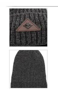 Detail of chenille knit beanie showing snowflake leather patch and rib texture