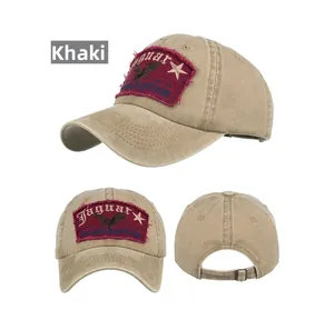Detail view of the khaki baseball cap showing eagle embroidery and adjustable metal buckle