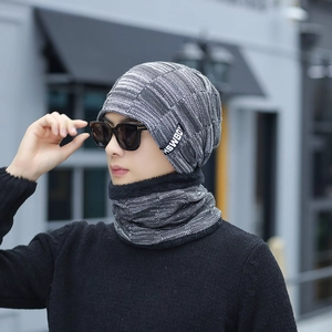 Detail of men winter knitted hat and neck warmer set with warm fleece lining in grey