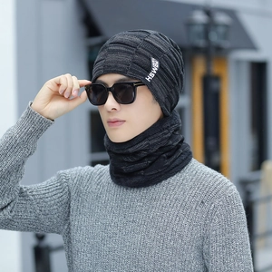 Detail of grey knitted winter hat and neck gaiter set with fleece lining for men