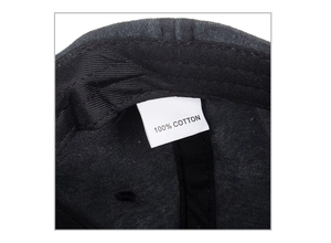 Close-up detail of the 100% cotton material tag and inner stitching of this baseball cap