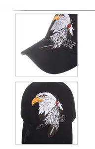 Close-up of eagle head embroidery and Native Pride text on a black cotton baseball cap