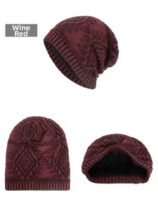 Detail view of wine red knit beanie showing geometric pattern and thick black fleece lining