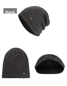 Detailed view of knitted beanie with houndstooth pattern and thick black fleece lining