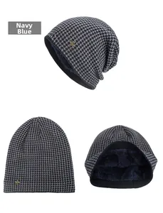 Detail view of navy blue houndstooth knit beanie with thick fleece lining and metal logo