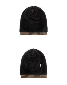 Detail of black knit beanie with thick fleece lining and brown ribbed cuff for winter warmth