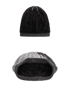 Detail of cable knit beanie with thick thermal faux fur lining for winter warmth