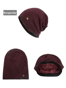Close-up of burgundy houndstooth knit beanie with warm fleece lining and metal H detail