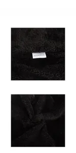Detail display of black 100% acrylic knit fabric with soft fleece texture and care label
