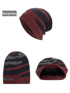 Detail view of the thick black fleece lining inside the wine red striped knit beanie hat