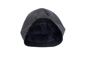 Detail of winter knit hat featuring houndstooth pattern and thick faux fur thermal lining