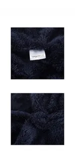 Detail shot of navy blue 100% acrylic knitted fabric with soft fluffy fleece texture