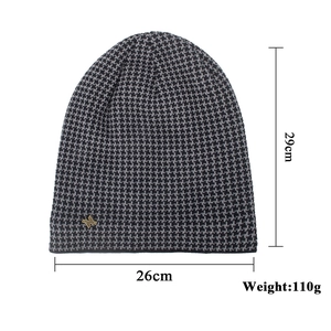 Winter long knit beanie with black and grey houndstooth pattern and gold shield badge