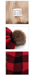 Detail of red plaid knitted hat with faux fur lining and 100% acrylic material tag