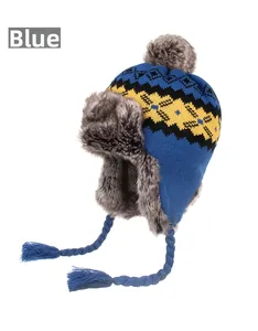 Detail of blue knitted winter earflap hat with yellow diamond pattern and plush lining