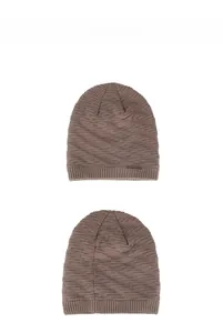 Détail du bonnet en maille marron café montrant le tissage épais en spirale et l'écusson
