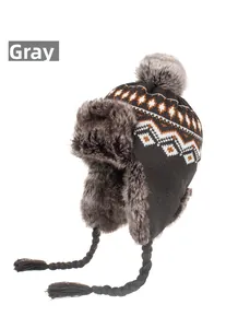 Detailed view of grey knit trapper hat with soft faux fur lining and pom pom