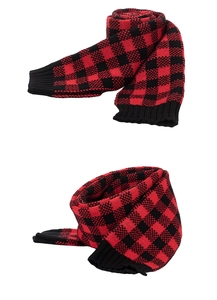 Close-up detail of red and black buffalo plaid knitted scarf with black ribbed edges