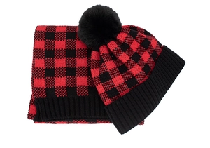 Detail of red and black buffalo check knitted winter hat and matching scarf set
