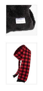 Detail of red and black checkered knit scarf with soft faux fur lining and acrylic tag
