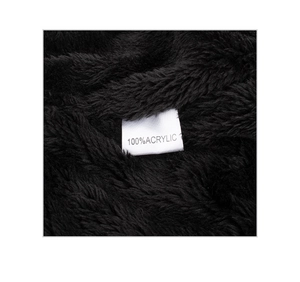 Macro shot of 100% acrylic care label on black faux fur winter hat lining detail