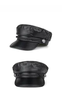 Detail view of black PU leather baker boy hat featuring woven rope and metal side buttons