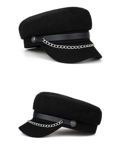 Detail view of black wool captain hat featuring silver metal chain and anchor buttons