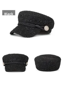 Detail of black tweed baker boy hat featuring woven rope trim and retro metal buttons