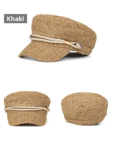 Detail of khaki tweed baker boy hat featuring braided rope and vintage metal buttons