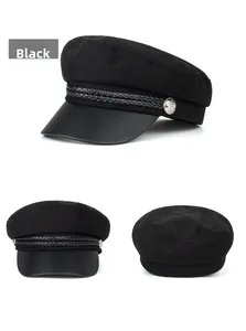 Detailed view of black wool newsboy cap featuring leather brim and metallic button accents