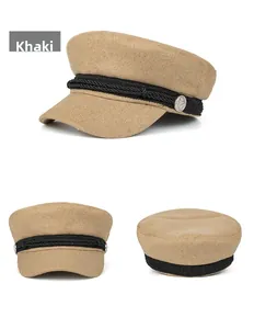 Detail view of khaki wool sailor cap with black braided strap and silver anchor buttons