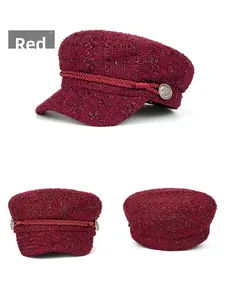 Detailed view of wine red tweed newsboy cap showing woven texture and vintage metal buttons