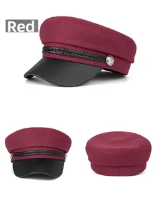 Detail view of burgundy wool baker boy hat with black leather brim and silver buttons