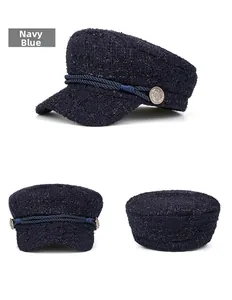 Three-side view of navy blue tweed baker boy hat with golden buttons and braided strap