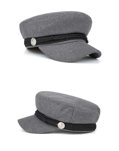 Detail view of grey wool navy style beret featuring silver anchor buttons and woven strap