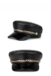 Detailed view of black PU leather baker boy hat with glossy brim and gold chain