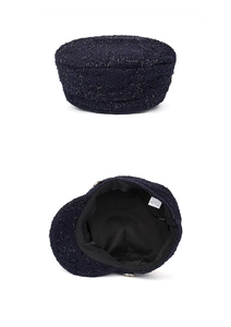 Detailed view of navy tweed baker boy hat with metal buckle and soft inner lining