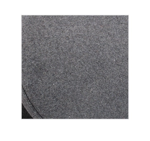 Macro view of light grey wool felt fabric texture with neat curved stitching on the cap