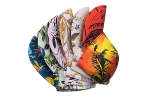 Detailed close-up showing various floral and tropical print patterns on cycling caps