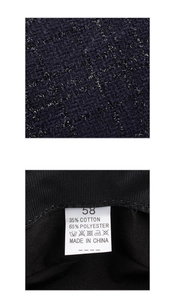 Macro view of blue tweed fabric texture and care label showing 58 size and cotton blend