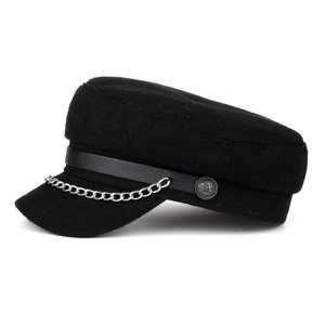 Black wool newsboy cap featuring a faux leather strap and decorative silver metal chain