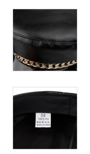 Detail view of black PU leather beret featuring a chunky gold chain and interior size tag